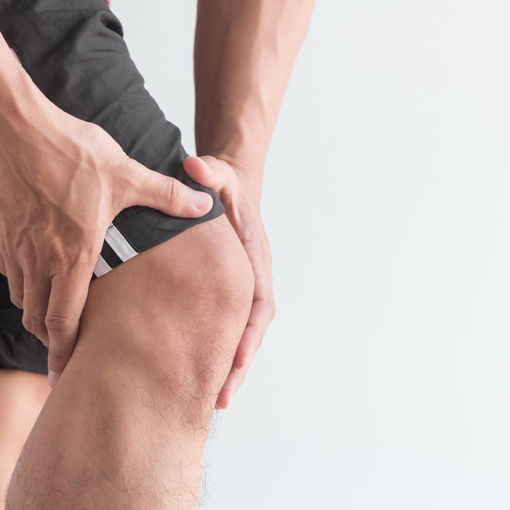 young man with knee pain and copy space